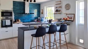 a kitchen with a counter and stools in it at ThePearl in Sel