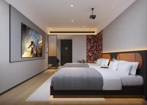 a bedroom with two beds and a painting on the wall at Mcsrh Hotel-Chongqing Jiefangbei Pedestrian Street in Chongqing