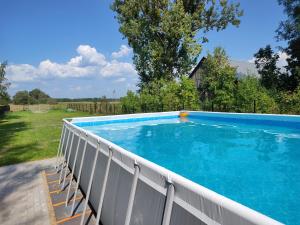 a large swimming pool with a white fence around it at Domek z bala na Podlasiu z balią ogrodową in Suszcza