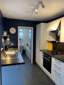 a kitchen with a sink and a stove at 3 Bed Family House Free Parking in Southend-on-Sea