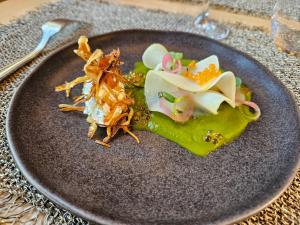 a plate of food with vegetables on a table at Logis Hôtel Restaurant Relais de la Mothe in Yzeures-sur-Creuse