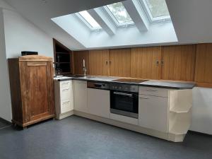 a large kitchen with a skylight in the ceiling at Chalet zur Eselei in Landsberg am Lech