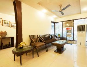 a living room with a couch and a table at Golden Leaf Hotel in New Delhi