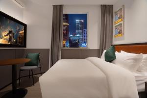Voodi või voodid majutusasutuse Mcsrh Hotel-Hangzhou Xihu toas