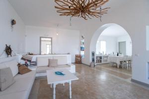 a living room with a couch and a table at Piperi On The Rocks in Naousa