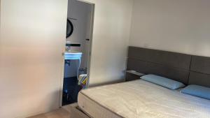 a small bedroom with a bed and a mirror at A DUE PASSI in Castel di Lama