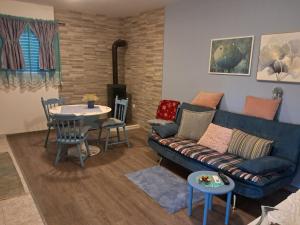 a living room with a couch and a table at BEllA in Sinj