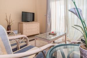 Televízia a/alebo spoločenská miestnosť v ubytovaní Apartamento 305 + 14 fotografií