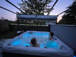 a couple of people in a hot tub at White House Izabelin Family SPA House near Warsaw in Mogielnica