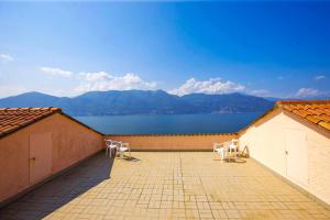 a patio with two chairs and a view of the water at Parco Belmonte: Vista Fantastica in Brezzo