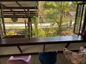 a table and two chairs in a room with a window at Napa White Villa river front in Ban Pang Mung +58 photos
