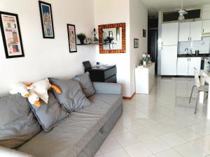 a living room with a couch with a stuffed animal on it at Bellavista apartment Letojanni in Letojanni