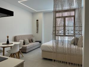 a living room with a bed and a couch at Apartments Vent de Vela in Valencia