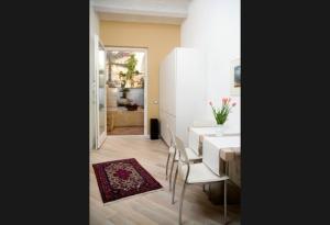 a dining room with a white table and chairs at Le Lumie in Modica
