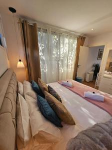 a large bed with pillows on it in a room at 205 Serenity in Cascais +64 photos