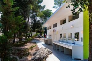 a building with a row of sinks on the side of it at Camping Park Soline Pitches in Biograd na Moru +21 photos