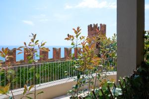 a balcony with a view of a brick building at Appartamenti Castello Borelli in Borghetto Santo Spirito