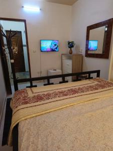a bedroom with a large bed and a mirror at AMAL HoME in Ouagadougou +18 photos