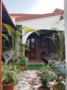 a house with a courtyard with plants in it at AMAL HoME in Ouagadougou