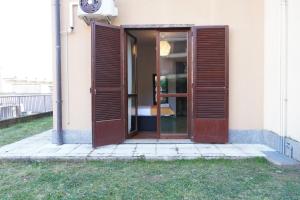 an open door of a house with a window at Roma 2 Apartment - THE V Collection in Turate