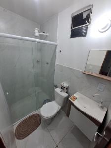 a bathroom with a shower and a toilet and a sink at Vista Mar Emboaca in Estrela +6 photos