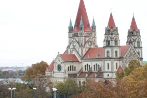 a building with two towers with trees in front of it at Home Sweet Home - Leopold in Vienna