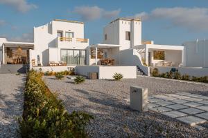 a white house with a lot of windows at Villa Kaya, Plaka in Naxos Chora