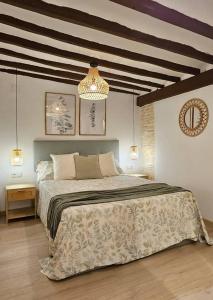 a bedroom with a large bed and a chandelier at LovelyLoft Trafalgar in Alicante