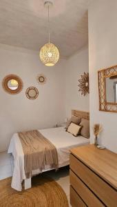 a bedroom with a bed and a chandelier at LovelyLoft Trafalgar in Alicante