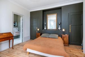 a bedroom with a bed and a desk and a mirror at Green Place - Amazing house with swimming pool in Caluire-et-Cuire