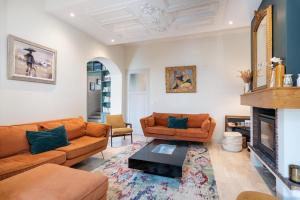 a living room with two couches and a fireplace at Green Place - Amazing house with swimming pool in Caluire-et-Cuire +33 photos