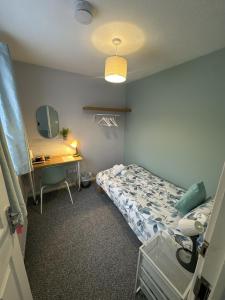 a hospital room with a bed and a desk at Inspire Home Stylish Stay B in Cardiff