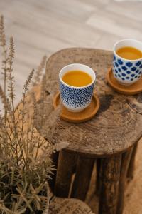 two cups of tea sitting on a wooden table at Yara Apt 40m from the Beach Jacuzzi & Rooftop in Agia Anna Naxos