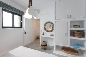 a bedroom with white cabinets and a mirror at Villa Andalusia in Naxos Chora +28 photos
