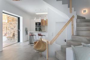 a kitchen and living room with stairs and a dining area at Villa Andalusia in Naxos Chora