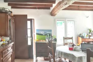 a kitchen with a table with a white table cloth at Maison rustique charmante à Sassetot-le-Mauconduit, jardin. in Sassetot-le-Mauconduit +16 photos