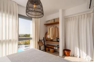 a bedroom with a bed and a large window at Villa Ama in Plaka +42 photos