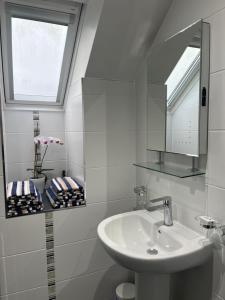 a white bathroom with a sink and a mirror at Elysian Fields B&B in Helston +37 photos