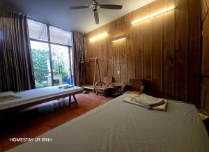 a bedroom with a bed and a table and a window at Út Bình Homestay in Vĩnh Long +12 photos