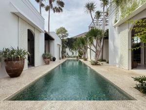 a swimming pool in the middle of a house at Poem House Bali in Munggu