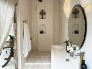 a bathroom with a sink and a mirror at Poem House Bali in Munggu +45 photos