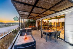 a restaurant with tables and chairs on a patio at Echinus Lara Hotel in Antalya