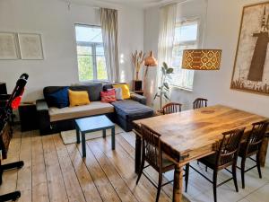 a living room with a couch and a table at Hillside view house with garden, private parking, quiet location - 12 min to Old town anytime, Long stays welcome in Vilnius