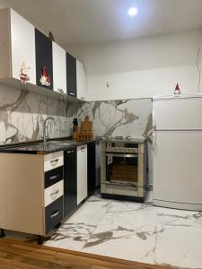 a kitchen with marble counter tops and a refrigerator at VILA JAHORINSKI RAJ A5 in Jahorina