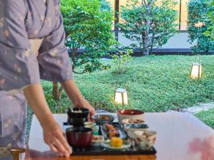 a woman standing in front of a table with a tray of food at Hotel Nikko Kumamoto in Kumamoto +37 photos