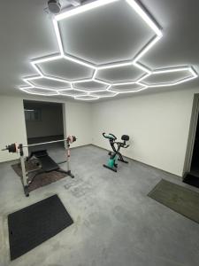 an empty room with a gym with a television and a treadmill at Gîte de la Chapelle-le houx in Innenheim