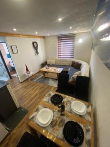 a living room with a couch and a table at VILA JAHORINSKI RAJ A5 in Jahorina