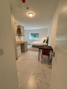 a kitchen with a table and a bed in a room at Rossaveal Farm in Leixlip +2 photos