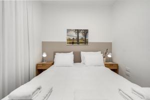 Giường trong phòng chung tại ULIVE Boutique ApartHotel