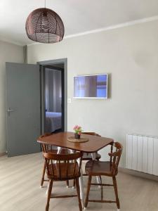 a dining room with a table and two chairs at Apartamentos Angelito Playa América Ático in Nigrán